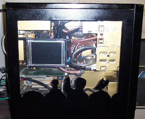 The silhouette of Mike and the bots, carved into an acrylic case window, point towards a darkened screen.